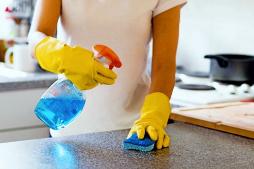 Local upholstery cleaner working on a corner sofa in Harrow