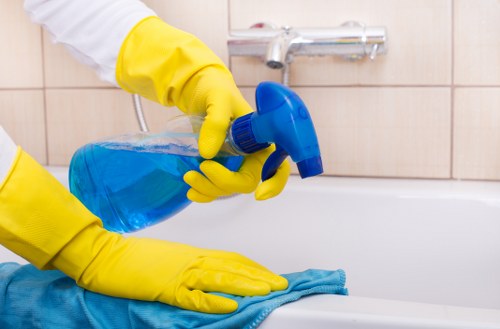 Technician treating stains on a mattress during a cleaning appointment