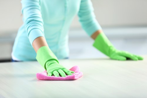 Cleaner using approved cleaning products with proper safety precautions