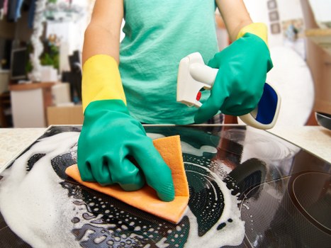 Domestic cleaner working in a Harrow kitchen and living space